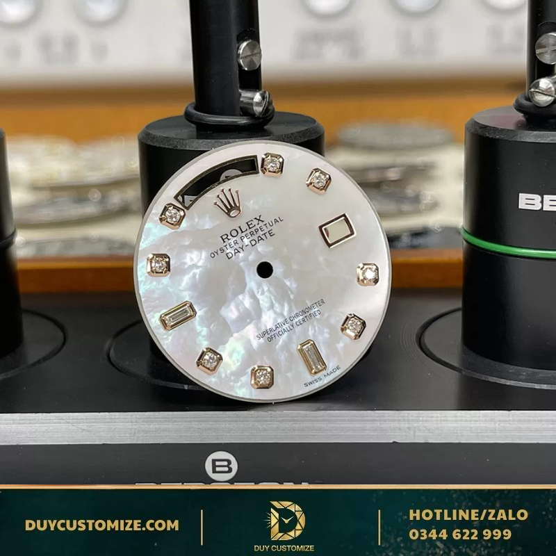 Rolex Day Date dial with mother-of-pearl inlay and diamond hour markers.